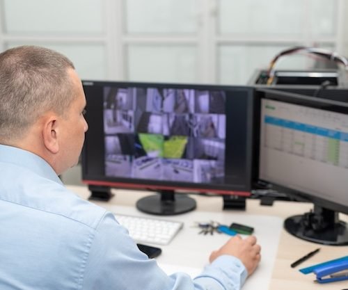 security-guard-monitoring-cctv-cameras-security-room_102556-1929